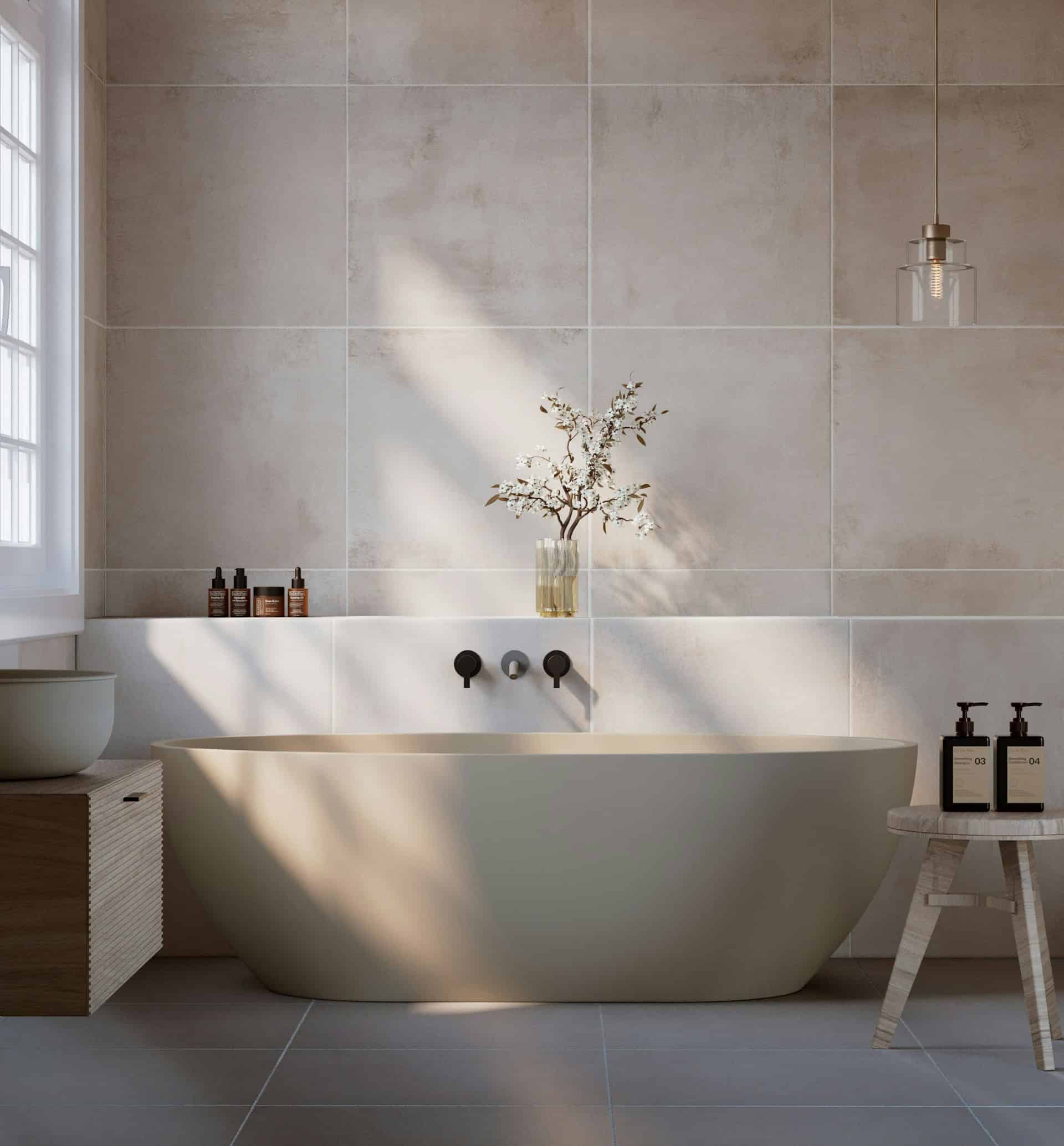 Neutral-toned bathroom with freestanding oval tub, natural stone tile walls, and pendant lighting